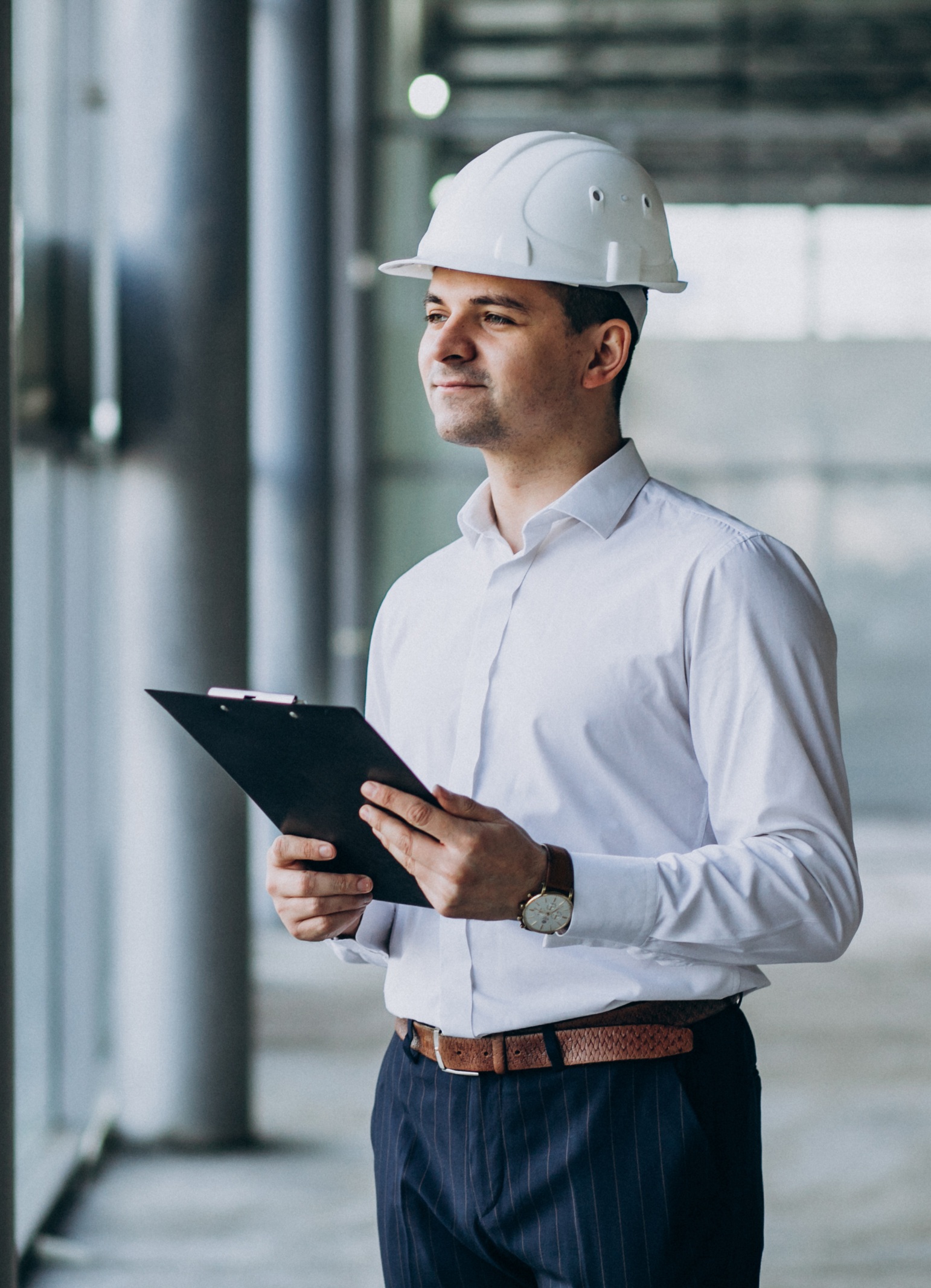 handsome business man engineer in hard hat in a building